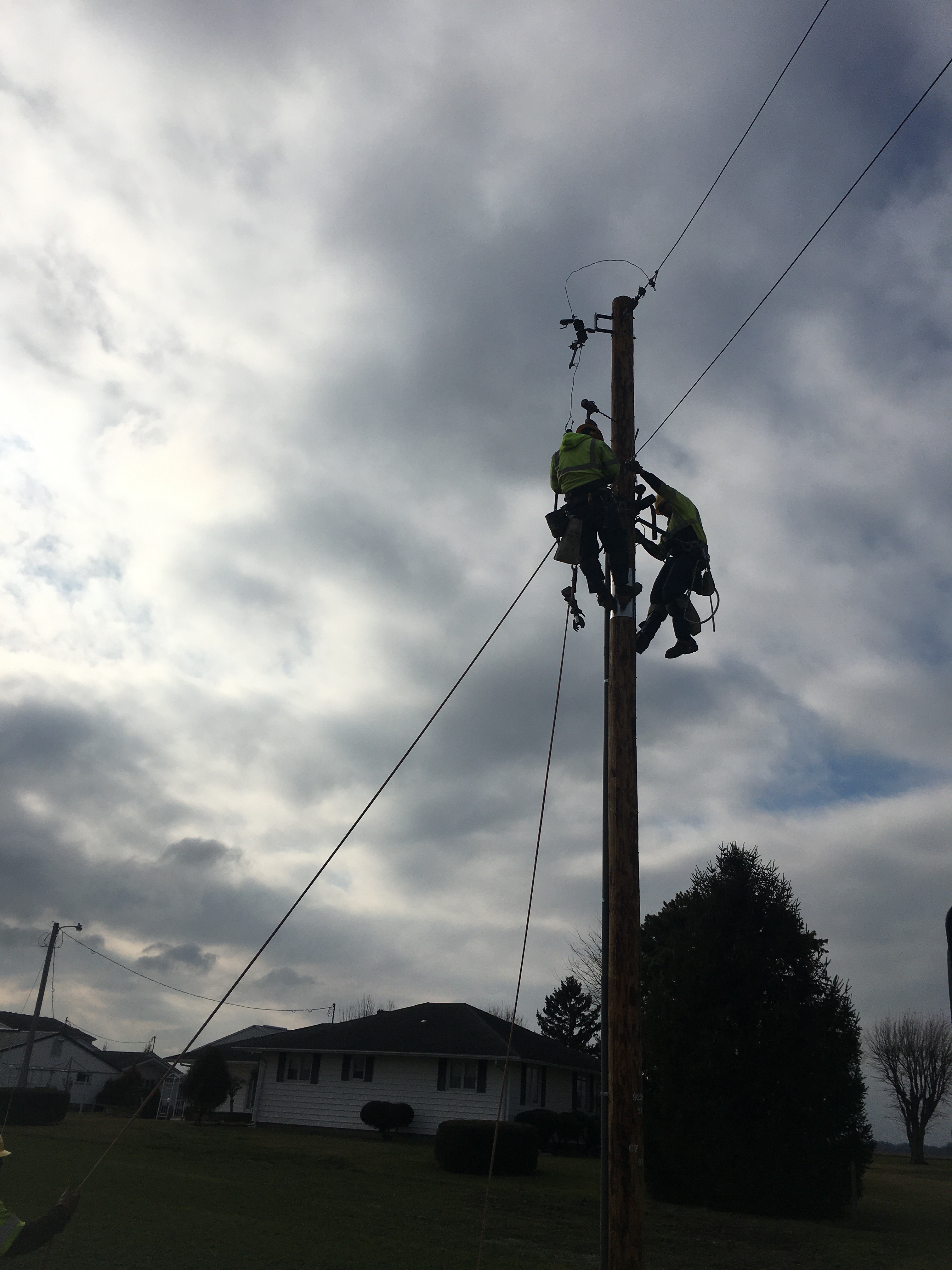 Andrew Hermiller and Adam Drummelsmith working on a pole transformer change-out in Kalida