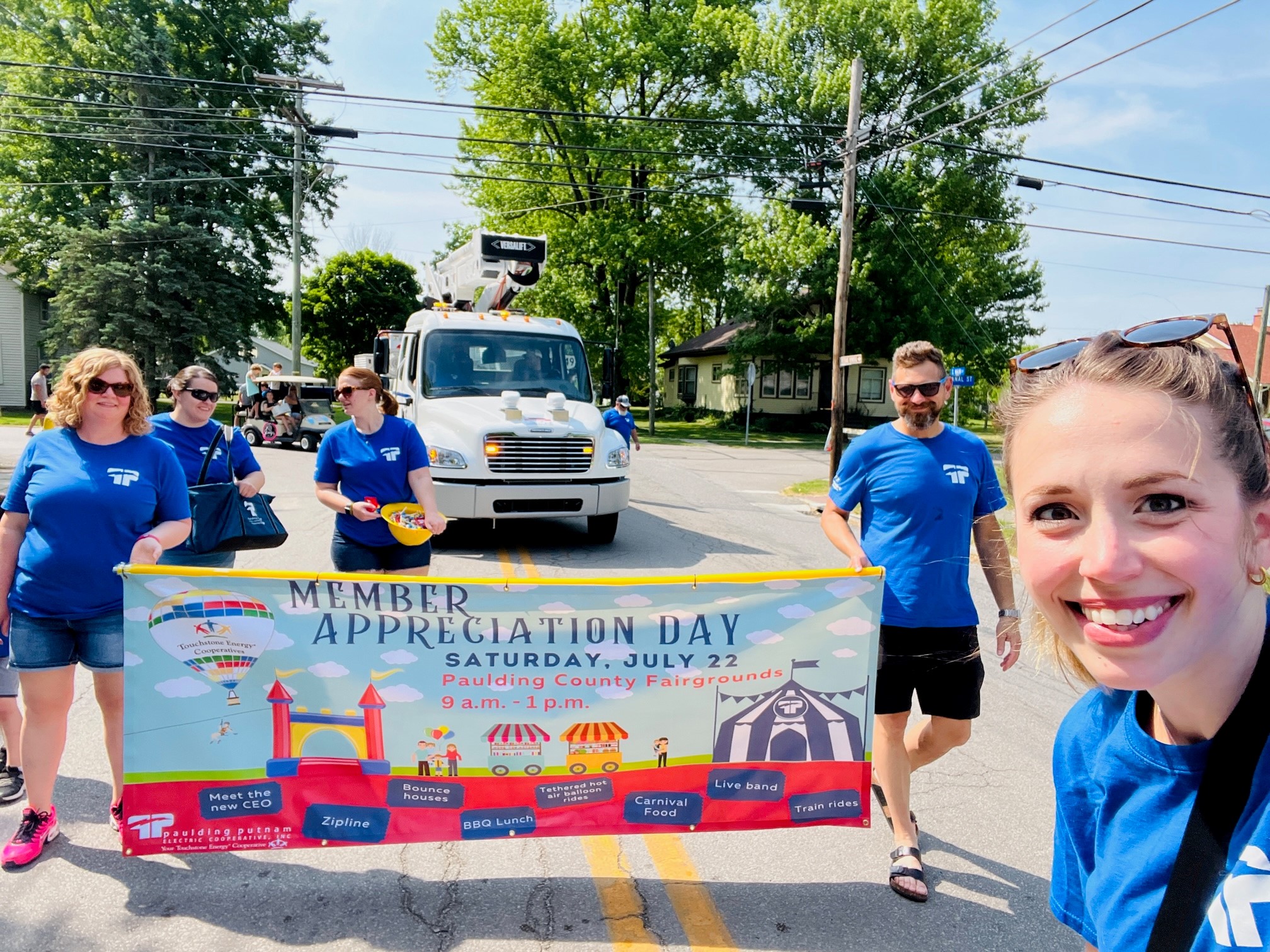 Samantha Kuhn poses with co-workers at Antwerp Days Parade in 2023