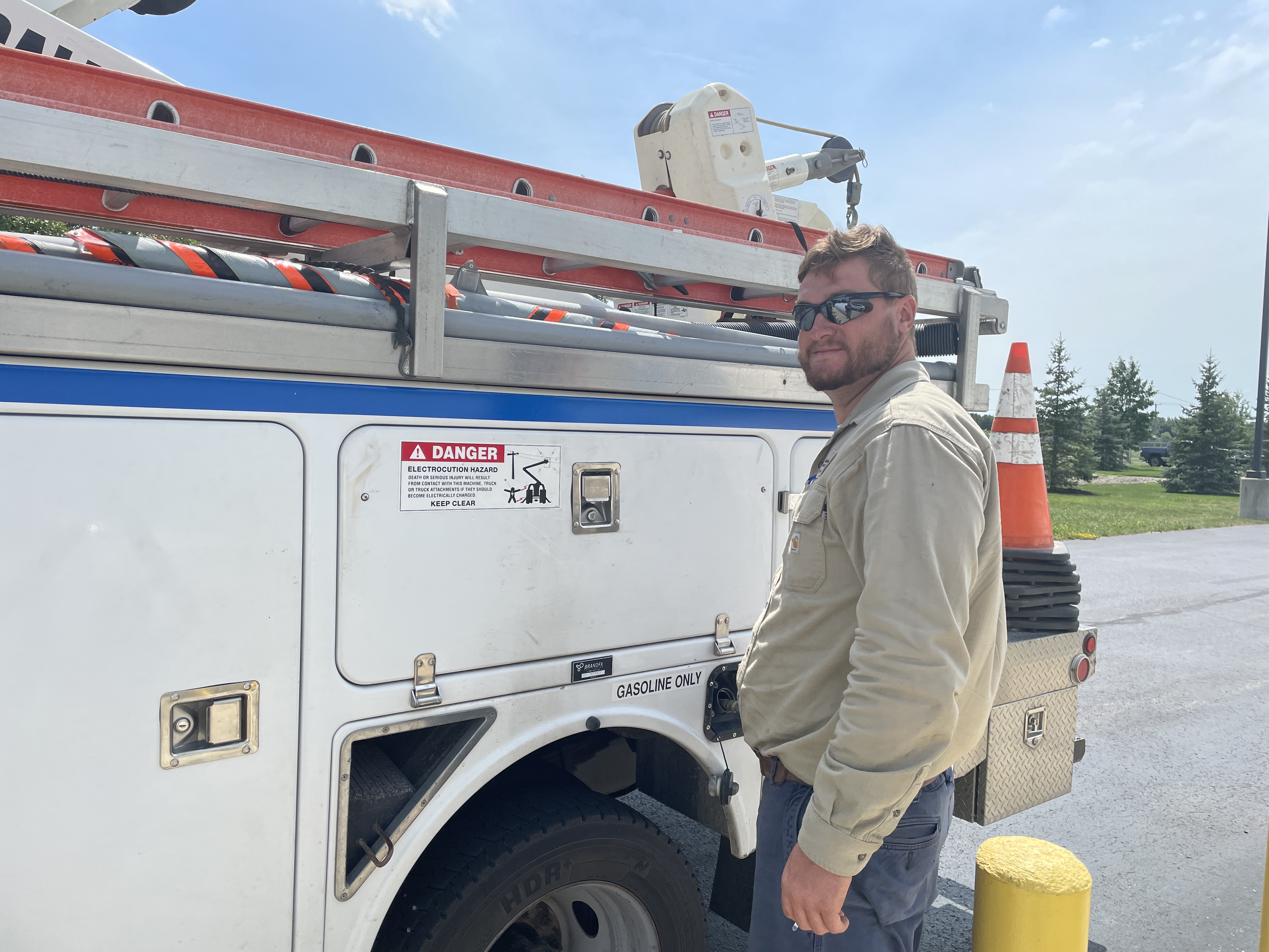 Lineman Adam D filling up bucket truck with gasoline