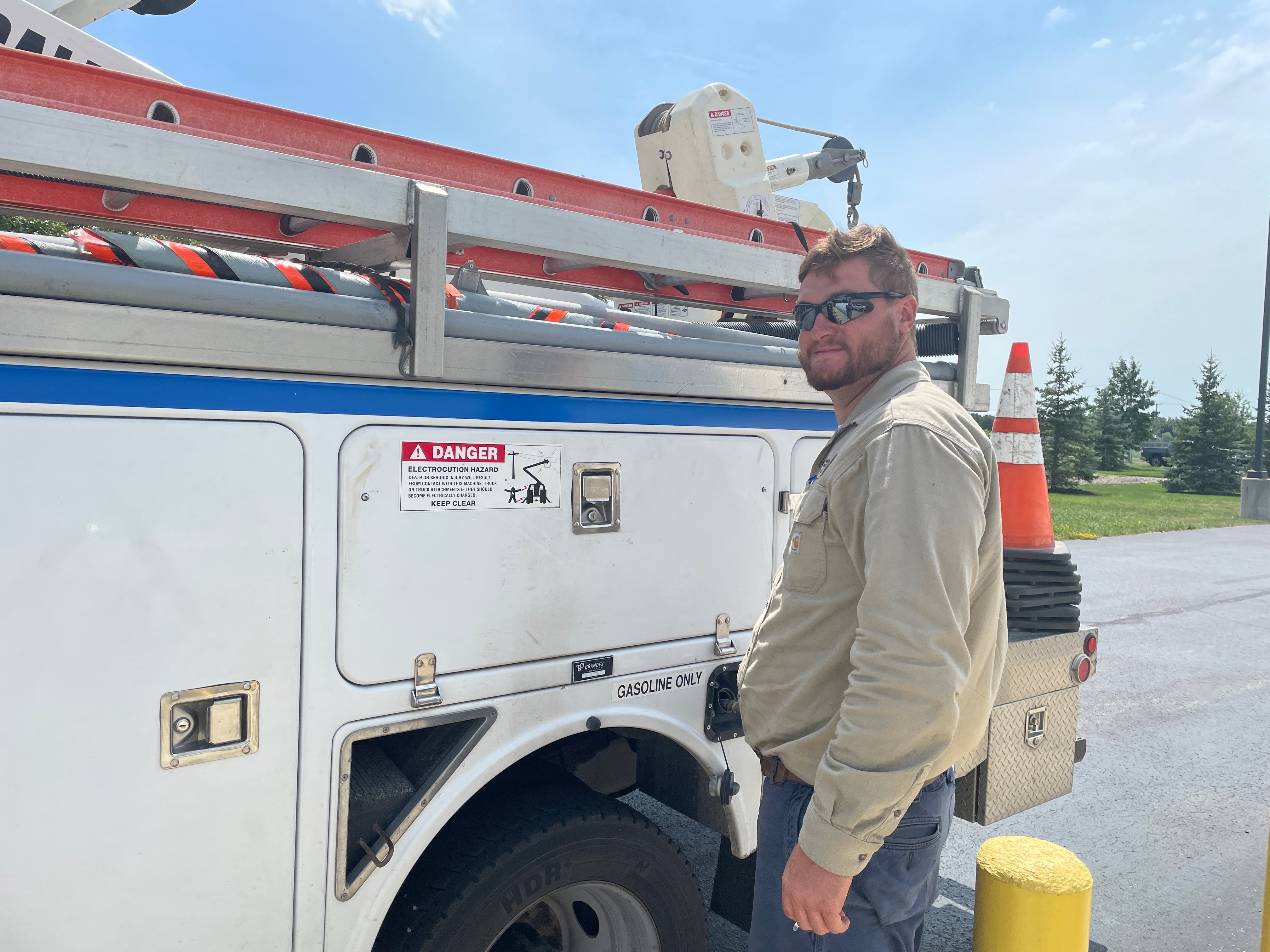 Lineman Adam D filling up bucket truck with gasoline