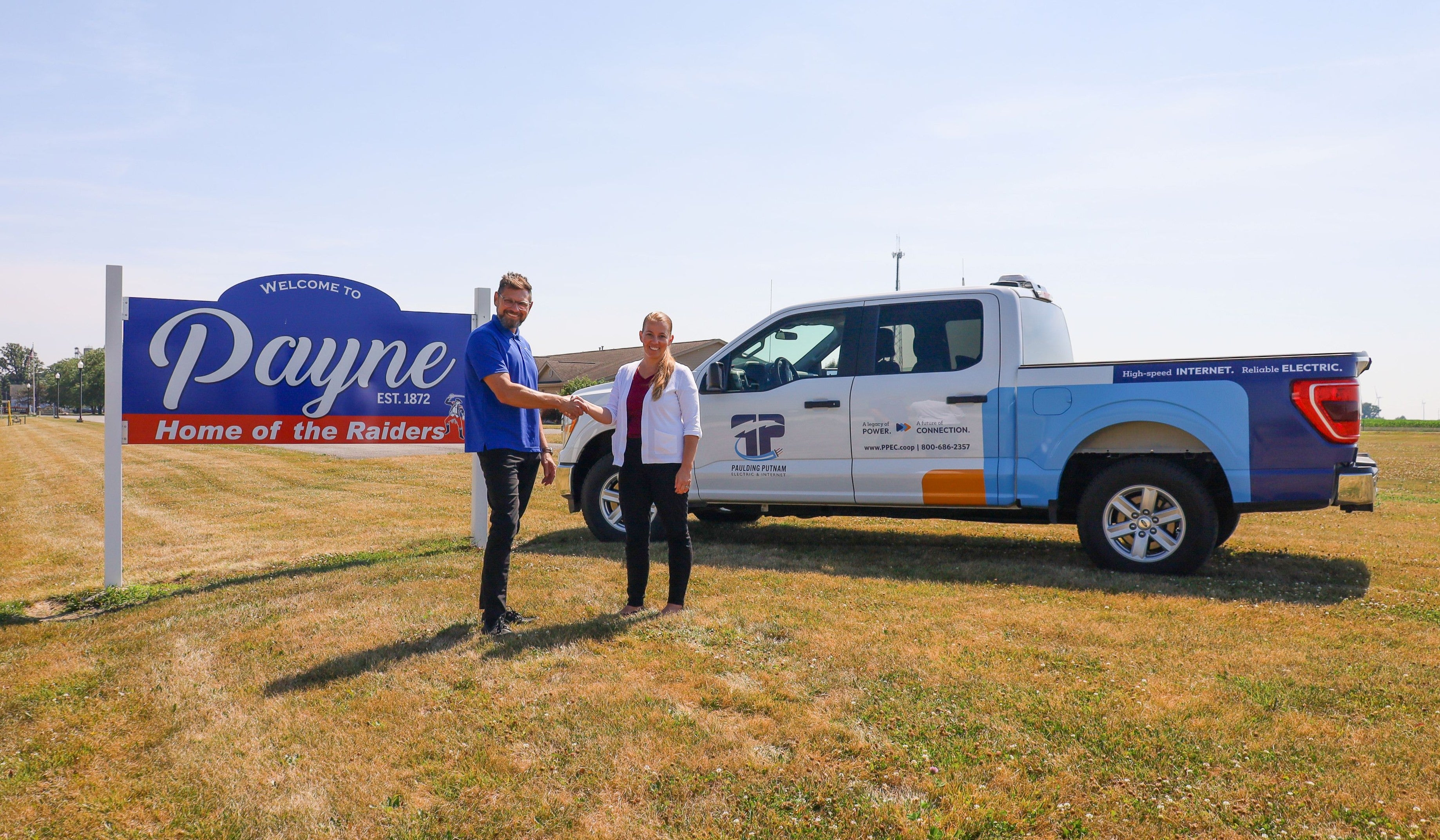 Paulding Putnam Business Development Coordinator Peter Niagu shakes hands with Payne Mayor Lora Lyons in July to signify new partnership.
