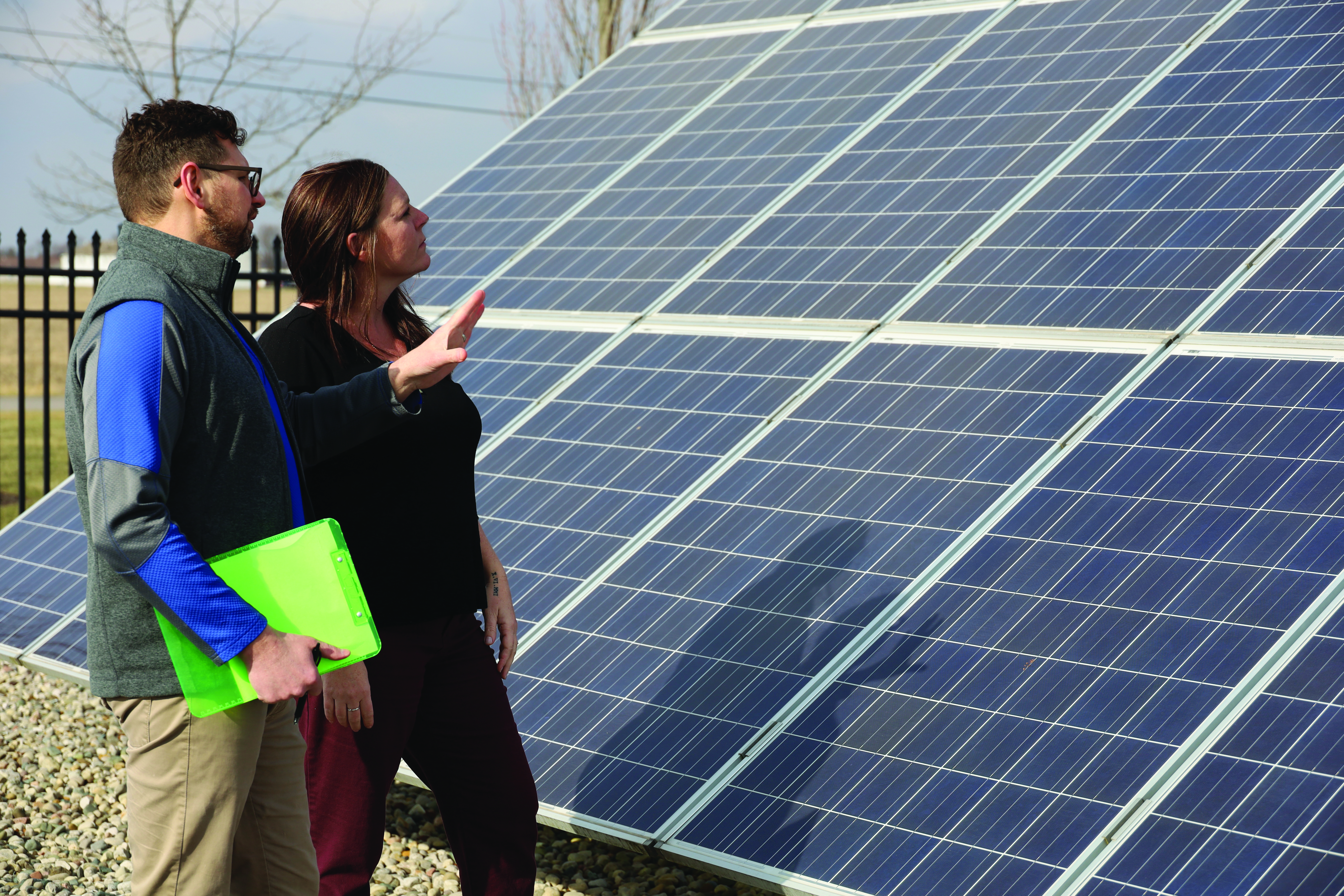 Peter Niagu and Kathy Kuckuck standing with a solar panel.