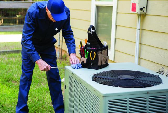 Repair man fixing a/c unit