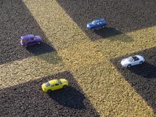 Picture of miniature cars parked within real parking spaces