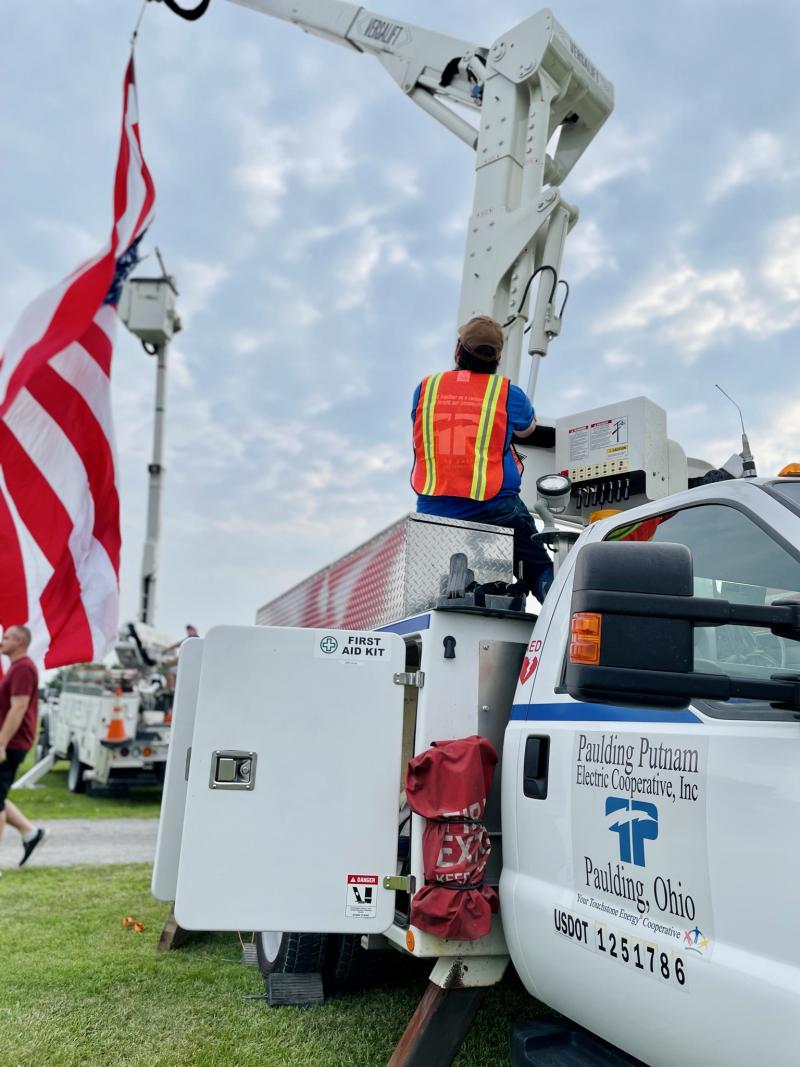 Mike on bucket truck with flag.JPEG